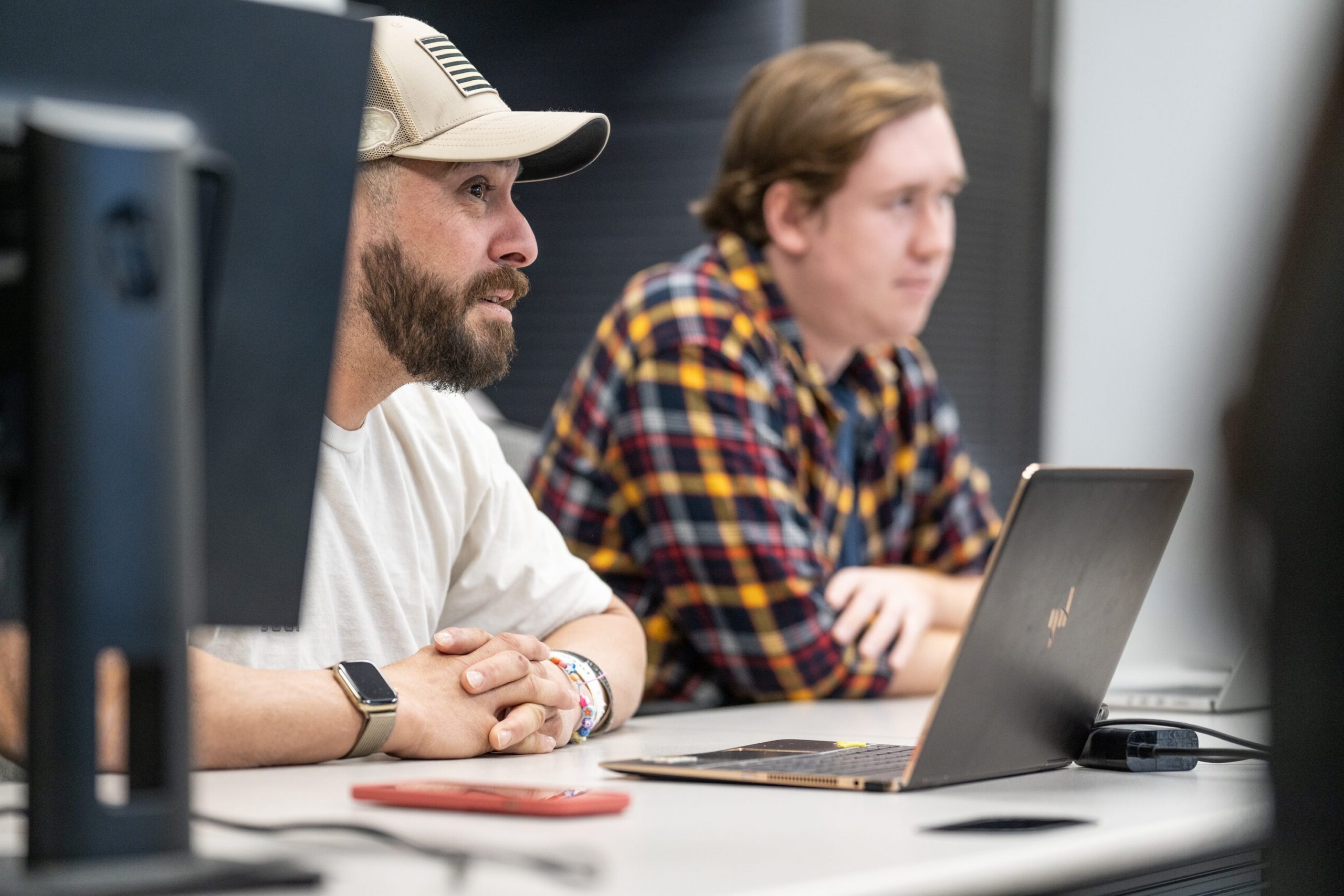 Two students learning about Python programming, data modeling, and data science at their Deep Dive Data Science bootcamp.