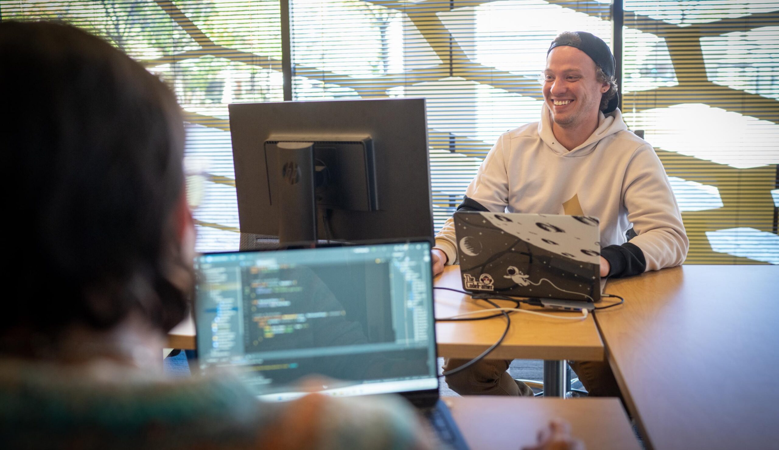 Two Deep Dive students working together on web development project in their Full Stack bootcamp.