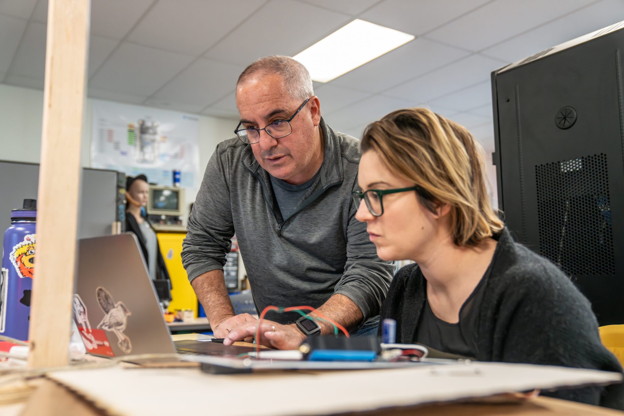 Deep Dive IoT instructor helping a student with rapid prototyping and smart product design concepts.