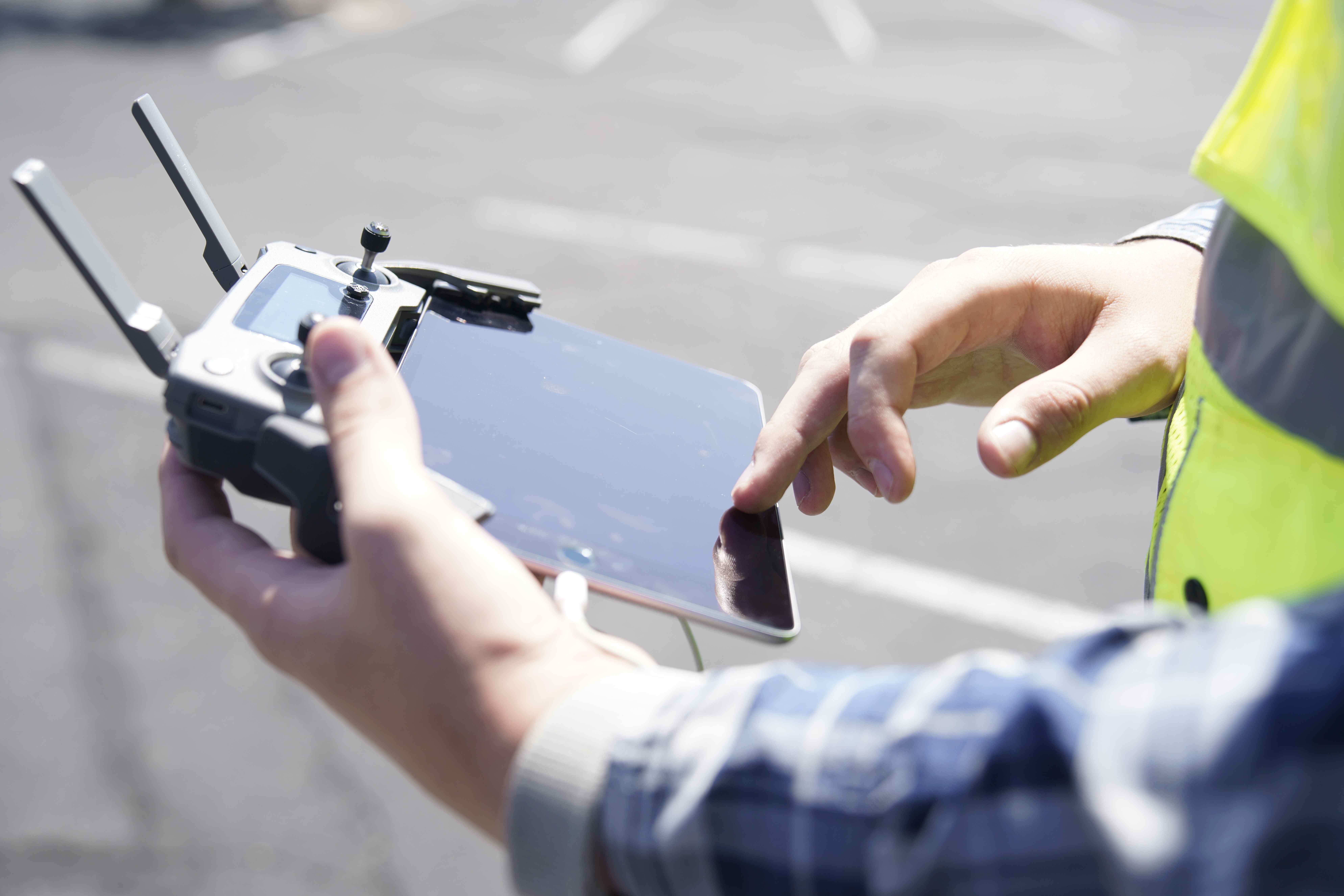 Student working the controls for a drone.